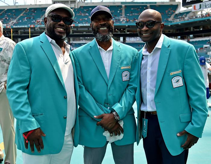 Former Dolphins running back Tony Nathan (center) stands with former wide receivers Mark Duper (left) and O.J. McDuffie (right) prior to a 2018 game against the Raiders at Hard Rock Stadium.